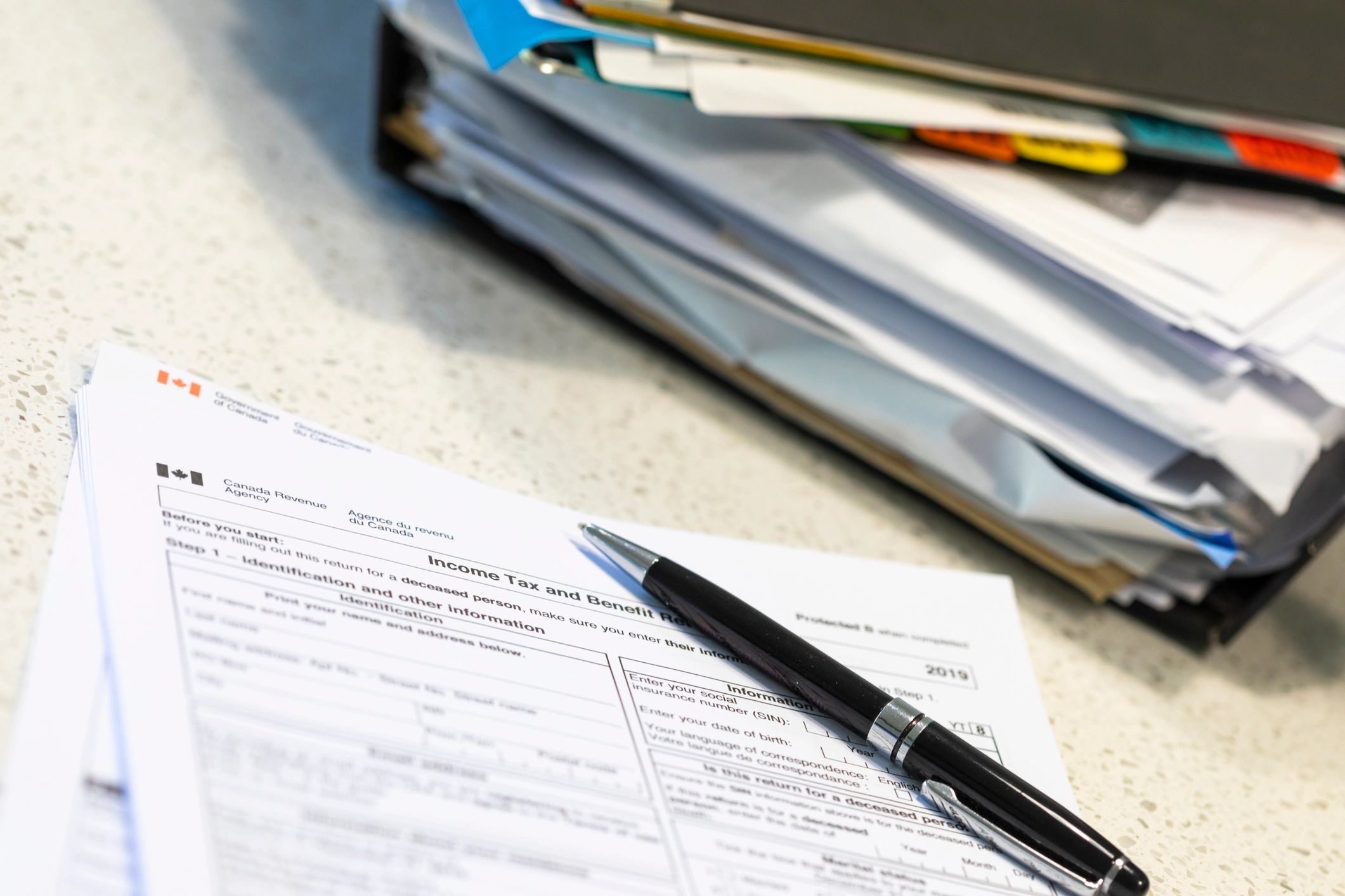 Tax filing paperwork and calculator on a desk