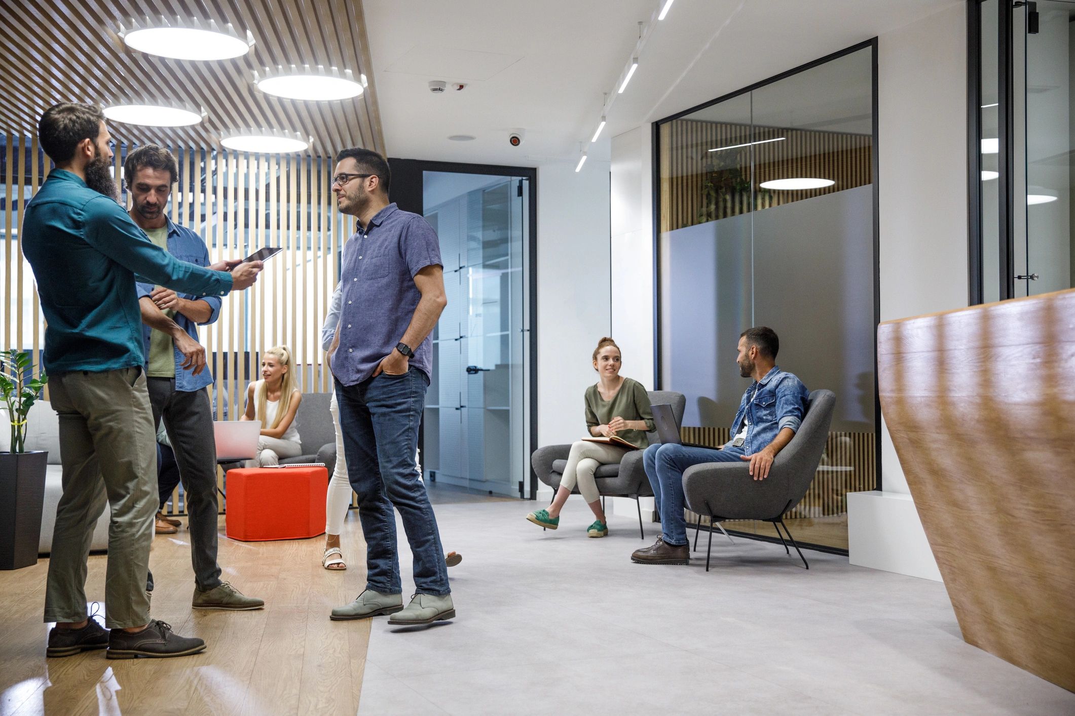 Team collaborating in a modern office lobby