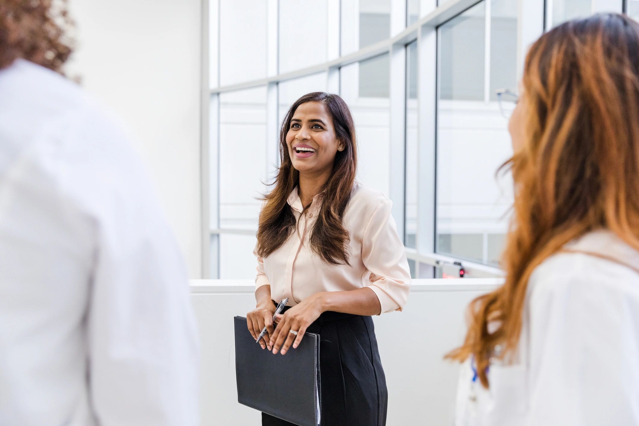 Professionals discussing work in an office setting
