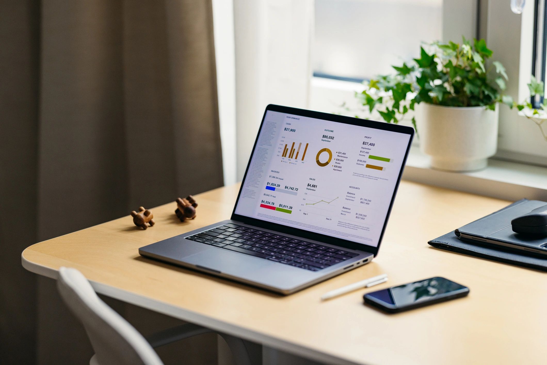Laptop and phone on an office desk representing online inquiries