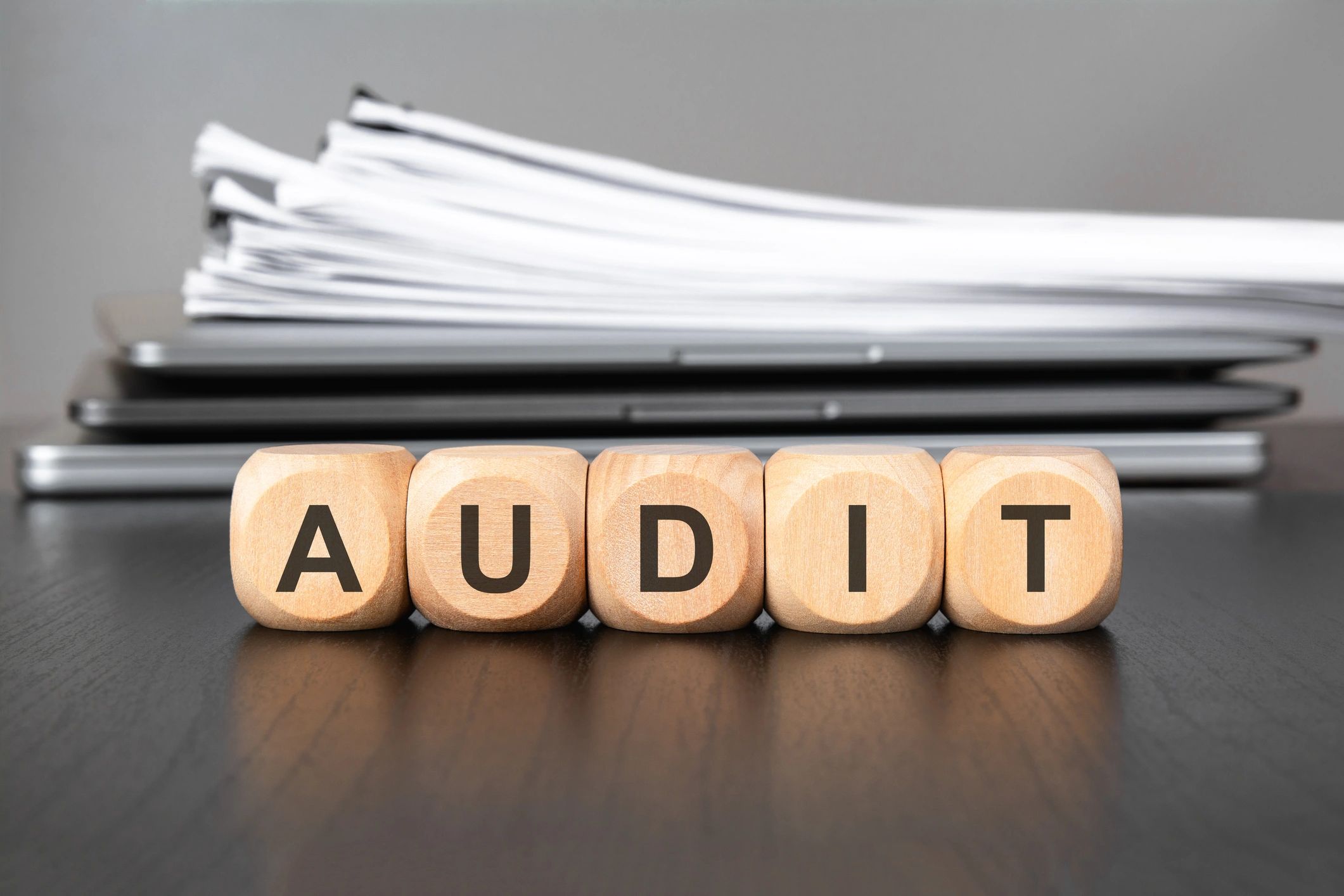 Audit and compliance concept with documents and laptop on desk